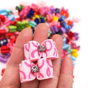 Macro shot of pink polyester pet hair bows with sparkling rhinestone center detail