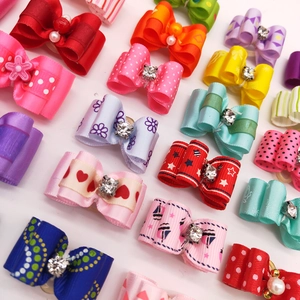 Close-up of colorful pet hair bows with rhinestones and pearls in a neat arrangement