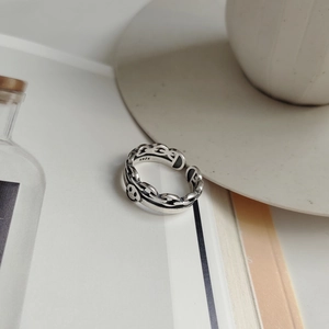 Macro shot of 925 sterling silver vintage smile ring on aesthetic magazine background