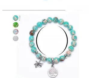 Detail of 8mm natural amazonite stone bracelet with tree of life and leaf pendants