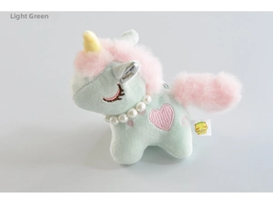 Detail of light green plush unicorn keychain with pearl necklace and heart embroidery