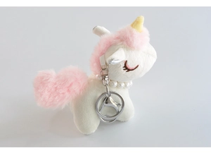 Detail view of white plush unicorn keychain with pink mane and faux pearl necklace