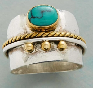 Close-up of vintage turquoise ring with gold rope border and silver hammered band detail