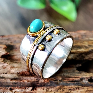 Vintage 925 style ring featuring a turquoise gemstone and gold accents on wide band