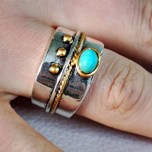 Vintage boho wide band ring with oval turquoise and gold accents on a silver finger ring