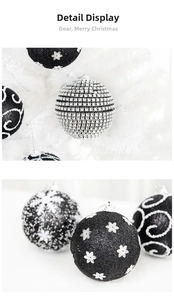 Detailed view of black and silver Christmas balls with snowflake and rhinestone patterns