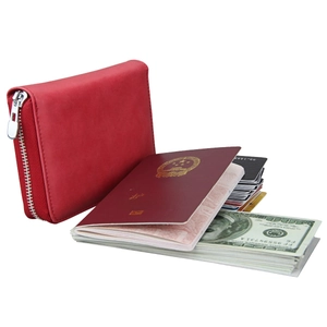 Detail view of red leather RFID passport wallet with multiple slots for cards and cash