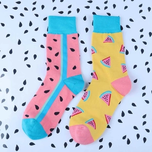 Flat lay of colorful cotton socks with vibrant pink and yellow watermelon fruit patterns