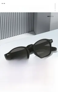 Detail of vintage black sunglasses with silver arrow rivets on a geometric background