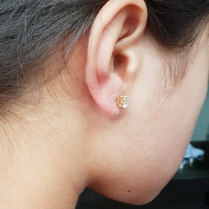 Detail of disposable ear piercing gun with a crown-shaped 316 steel gold zircon stud