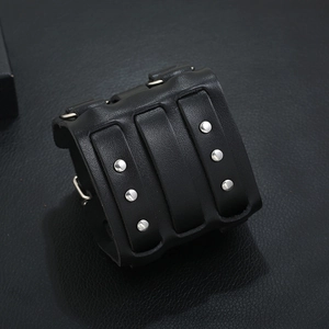 Punk wide black leather wristband with silver metal studs and three strap accents