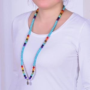 Detail of 108 turquoise beads wrap bracelet with colorful chakra stones and OM charm
