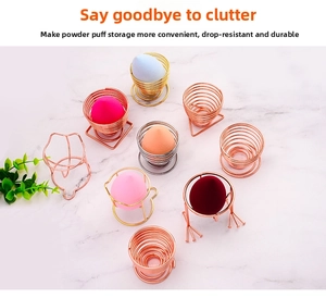 Detailed view of metal makeup sponge holders in rose gold and silver on marble