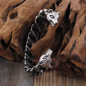 Retro punk wolf head open cuff bracelet in silver stainless steel on textured wood