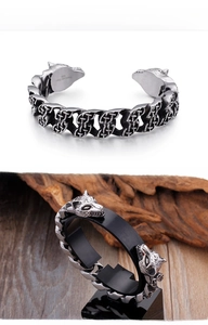 Detail of 316L stainless steel wolf head cuff with intricate Celtic knot engraving