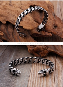Detailed view of skull element and woven leather chain on the stainless steel bracelet