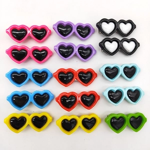 Colorful heart-shaped sunglasses hair clips for pets in a multi-color variety pack