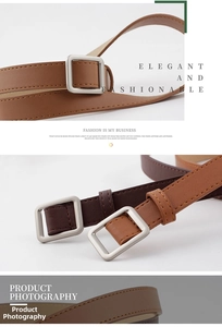 Macro detail of square matte silver buckle and stitched leather belt in brown and tan
