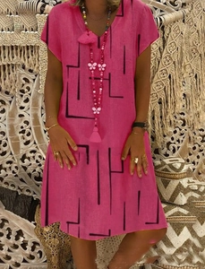 Close-up of V-neckline on rose pink dress with black geometric line patterns