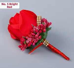 Detailed top view of red artificial rose boutonniere with berries and gold rhinestone