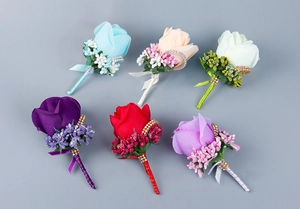 Detailed view of handmade silk rose boutonnieres with pearls and crystal accents