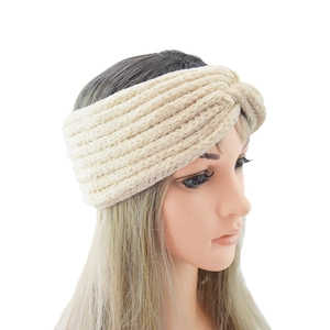 Close-up of beige chenille knitted twisted headband with soft ribbed texture and winter warmth