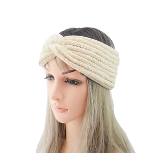 Detailed view of beige knit headband with crossover knot design and warm chenille texture
