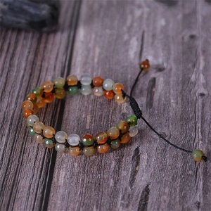 Detail of bohemian agate double-layer woven bracelet on a rustic wood surface