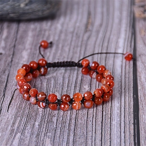 Macro view of double-layered faceted agate beads with natural textures and braided cord