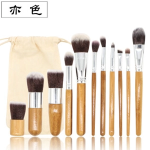 Detail of 11-piece makeup brush set with wooden handles and beige linen storage pouch