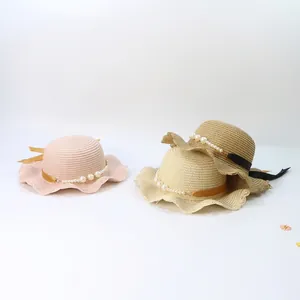 Kids woven straw sun hat with wavy brim, pearl beads and ribbon bow decoration