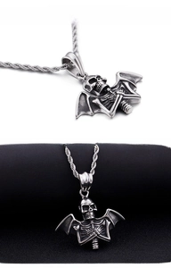 Close-up of vintage punk bat skeleton pendant with skull on a stainless steel twist chain