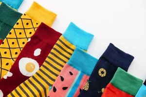 Close-up of cotton mid-calf socks featuring pineapple and watermelon patterns in vivid colors