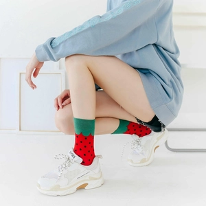 Close-up of strawberry pattern cotton crew socks featuring vibrant red and green colors