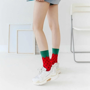 Close-up of strawberry pattern cotton crew socks worn with white sneakers for women