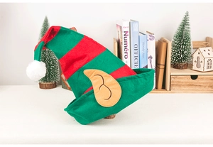 Detail of red and green striped Christmas elf hat with soft plush ball and funny elf ears
