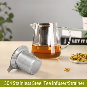 304 stainless steel fine mesh tea infuser with handle used with a glass teapot