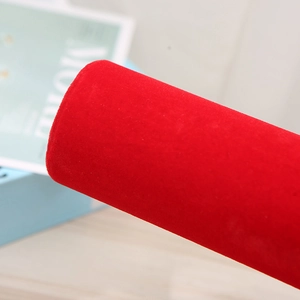 Detail of red velvet cylindrical display stand for bracelets and watches with fine texture