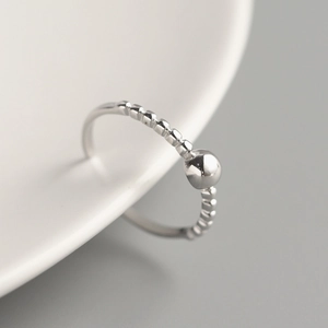Minimalist 925 sterling silver beaded open ring for women on white ceramic background