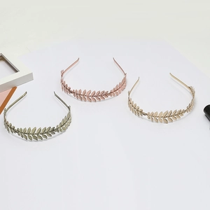 Three elegant metal leaf headbands in silver, rose gold, and gold finishes for women