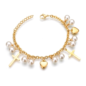 Close-up of double-layer gold chain bracelet with pearl, heart, and cross pendants