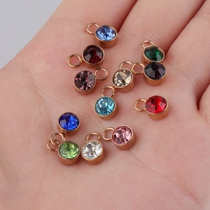 Set of twelve colorful round birthstone charms in gold-tone stainless steel bases