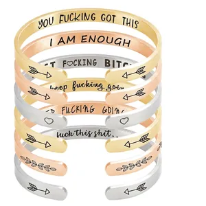 Stack of 6mm stainless steel open cuffs in gold, silver, and rose gold with engravings