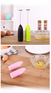 Close-up of handheld electric milk frother in three colors with stainless steel whisk