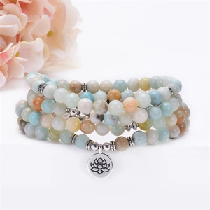 Detail of 8mm amazonite mala beads with lotus pendant and silver tree of life charm