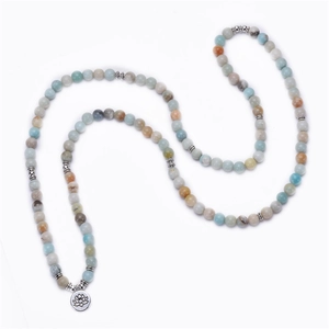 Macro shot of 8mm amazonite mala beads with detailed silver lotus flower pendant