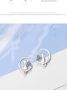 Close-up of cat on moon stud earrings with sparkling cubic zirconia on a white stand