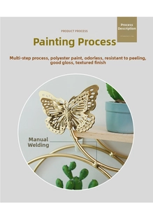 Detail of gold metal butterfly wall decor showing smooth finish and hand-welded joints