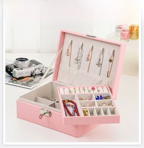 Pink leather double-layer jewelry box with metal lock shown in a stylish home setting
