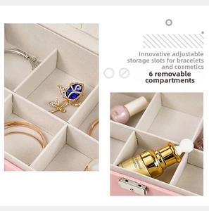 Pink leather jewelry box detail showing six compartments with removable dividers